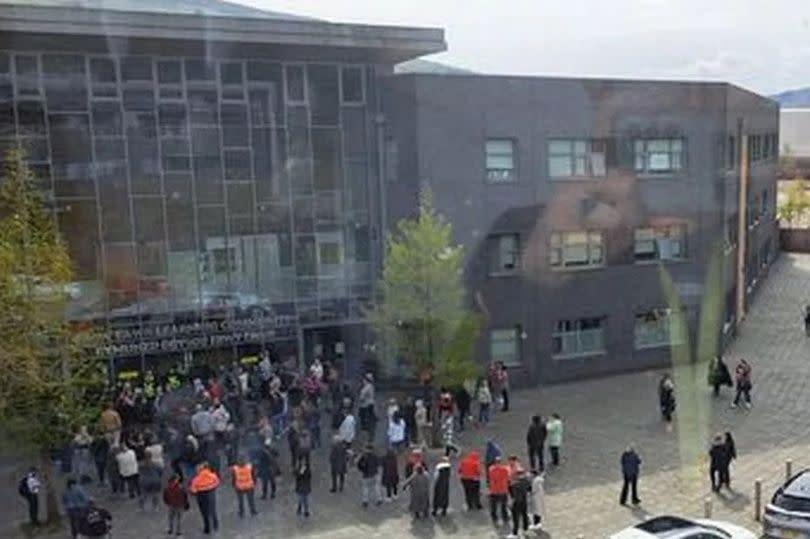 People outside Ebbw Fawr learning community in Ebbw Vale, South Wales, this morning