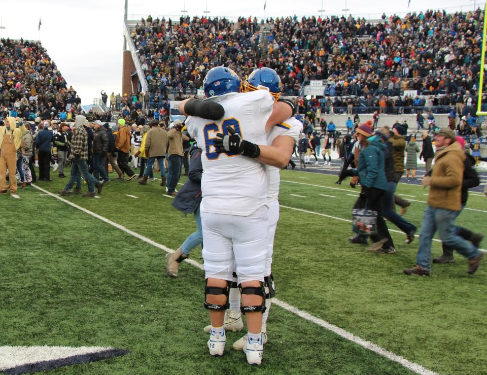 SDSU's Mason McCormick gets a hug from a teammate following Montana State's win in the FCS semifinals