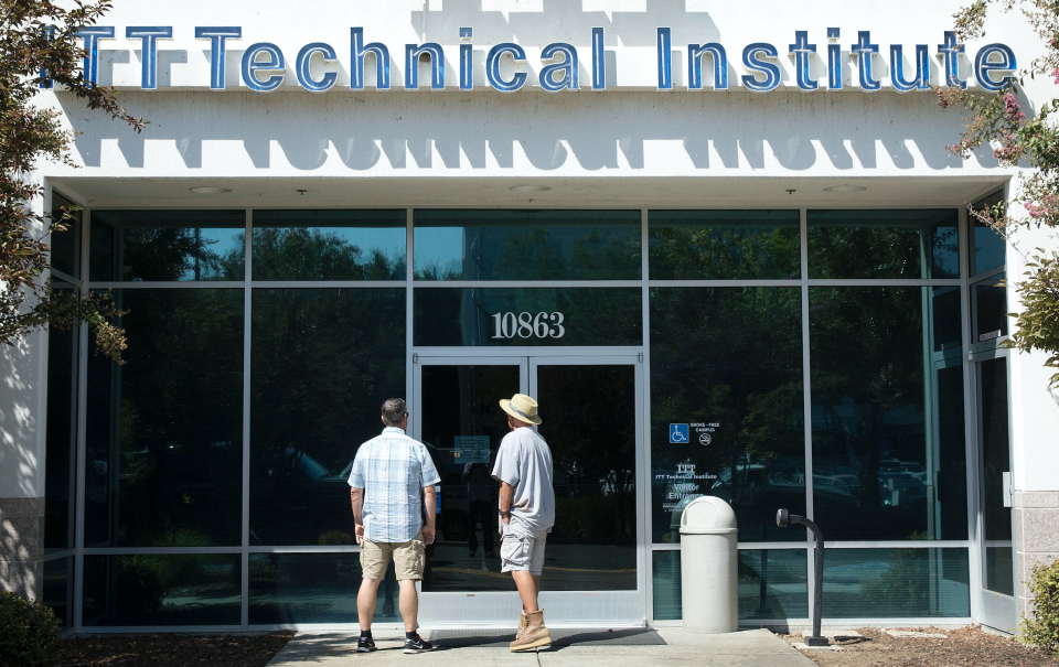 Harold Poling, left, and Ted Weisenberger check the doors to the ITT Technical Institute after ITT Educational Services announced that the school had ceased operating in Rancho Cordova, Calif. on Sept. 6, 2016. (AP: Rich Pedroncelli)