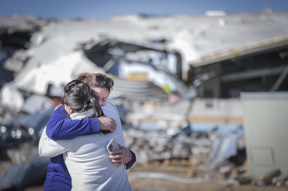 Crestview Elementary School teachers Anna Vandiver, left, and Elizabeth Woddell share a hug while visiting the mangled wreckage of their classrooms Saturday, April 1, 2023 after a tornado ripped through the town of Covington, Tenn. Storms that spawned possibly dozens of tornadoes have killed several people in the South and Midwest. (Patrick Lantrip/Daily Memphian via AP)
