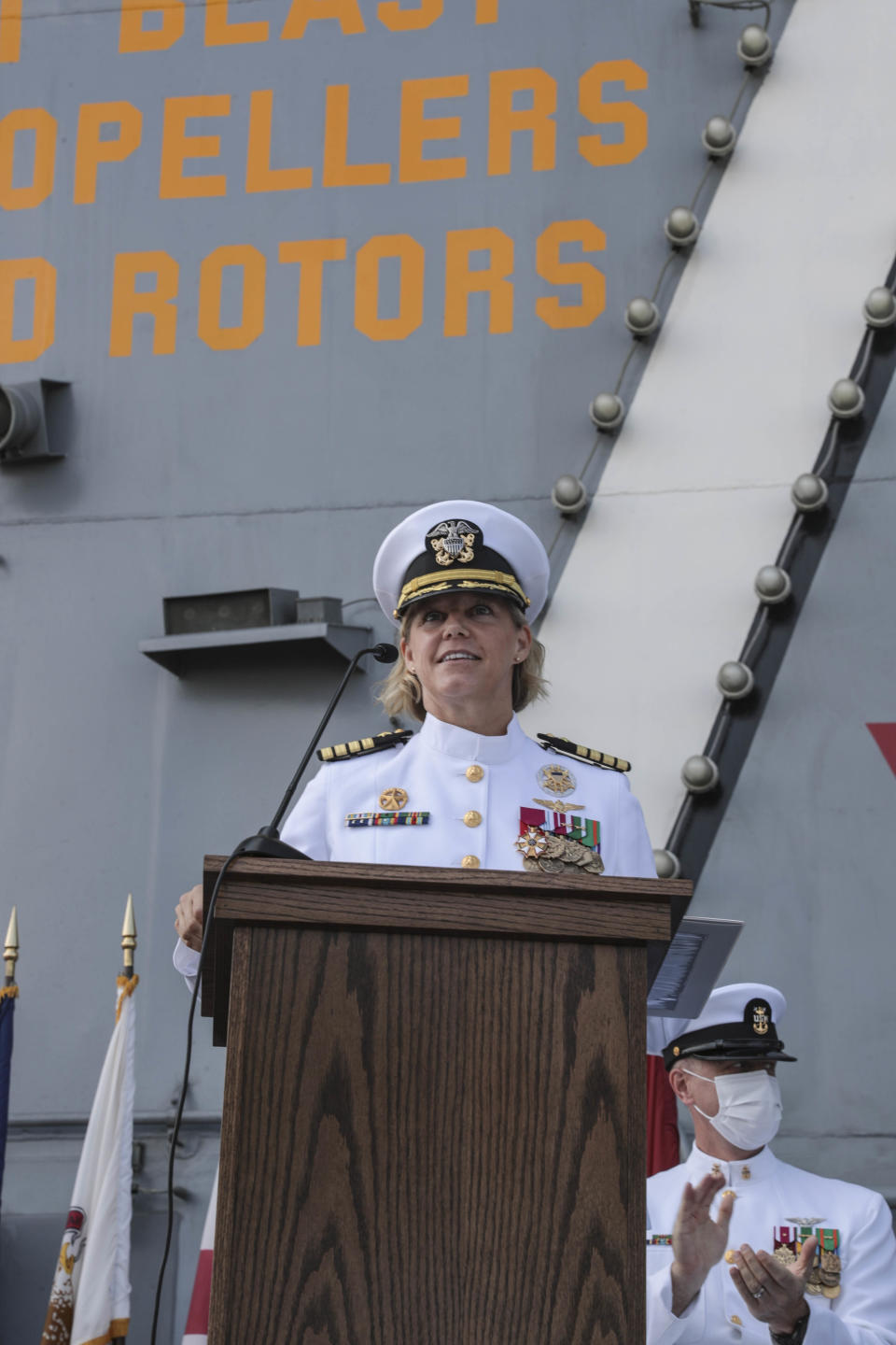 In this photo released by the U.S. Navy, Capt. Amy Bauernschmidt, newly appointed commanding officer of the aircraft carrier USS Abraham Lincoln, delivers remarks during a change of command ceremony held on the flight deck on Aug. 19, 2021. Capt. Walt "Sarge" Slaughter, right, successfully completed his 26 month tour as commanding officer during which Abraham Lincoln completed a 10-month combat deployment, the largest carrier work package ever completed in San Diego, and returned to sea in preparation for an upcoming deployment amidst the COVID-19 pandemic. Slaughter was relieved by Capt. Amy Bauernschmidt. The USS Abraham Lincoln deployed Monday, Jan. 3, 2022, from San Diego under the command of Capt. Amy Bauernschmidt, the first woman to lead a nuclear carrier in U.S. Navy history. (Mass Communication Spc. 3rd Class Jeremiah Bartelt/U.S. Navy via AP)