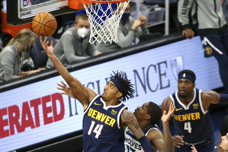 Denver Nuggets guard Gary Harris (14) shoots against Minnesota Timberwolves center Ed Davis (17) as Nuggets guard Paul Milsap (4) looks on in the second quarter during an NBA basketball game, Sunday, Jan. 3, 2021, in Minneapolis. (AP Photo/Andy Clayton-King)