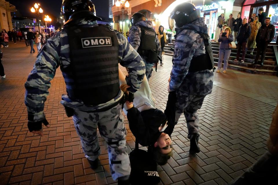 Riot police detain a demonstrator during a protest against mobilization in Moscow, Russia, Wednesday, Sept. 21, 2022. Russian President Vladimir Putin has ordered a partial mobilization of reservists in Russia, effective immediately.