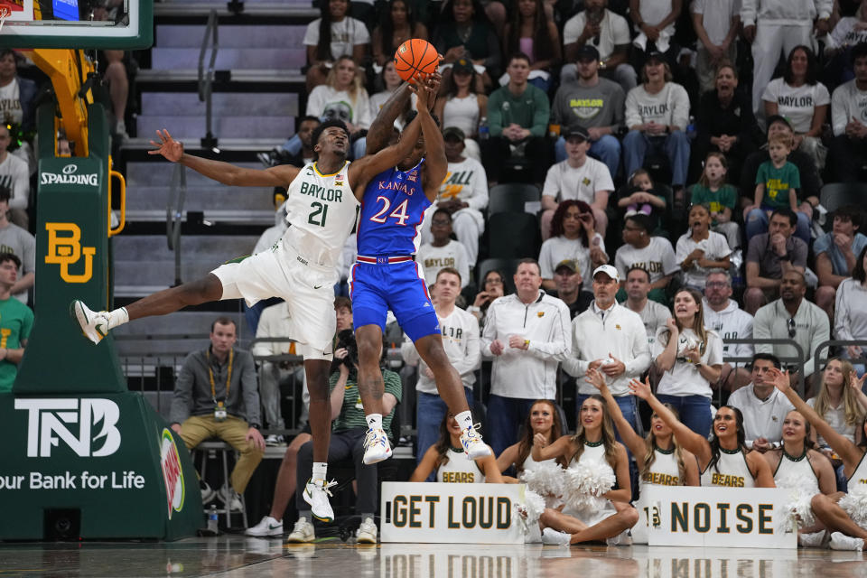 Baylor's Yves Missi (21) tries to breakup a pass intended for Kansas's K.J. Adams Jr. (24) during the first half of an NCAA college basketball game, Saturday, March 2, 2024, in Waco, Texas. (AP Photo/Julio Cortez)