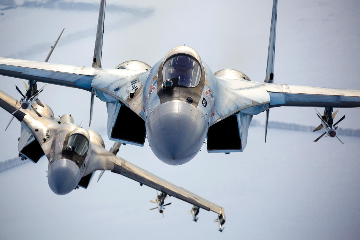 A pair of Russian Su-35 fighter jets fly in the sky.