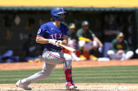 Texas Rangers' Josh Smith watches his RBI single against the Oakland Athletics during the second inning of a baseball game Tuesday, May 7, 2024, in Oakland, Calif. (AP Photo/Godofredo A. Vásquez)