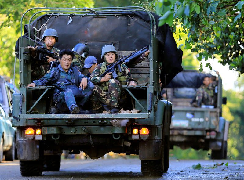 Government soldiers on military vehicles patrol after a continued assault on fighters from the Maute group who have taken over large parts of Marawi city, southern Philippines - Credit:  ROMEO RANOCO/Reuters