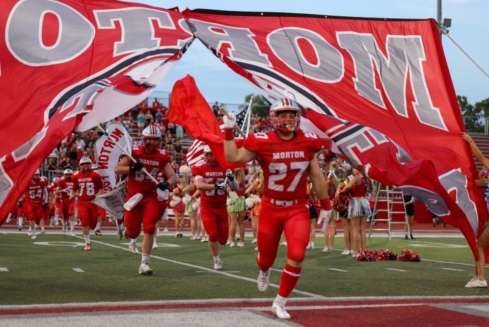 Morton senior fullback/linebacker Noah Losey, who has Narcolepsy, leads the team out onto the field on Opening Night at Carper Field on Friday, Aug. 25, 2023.