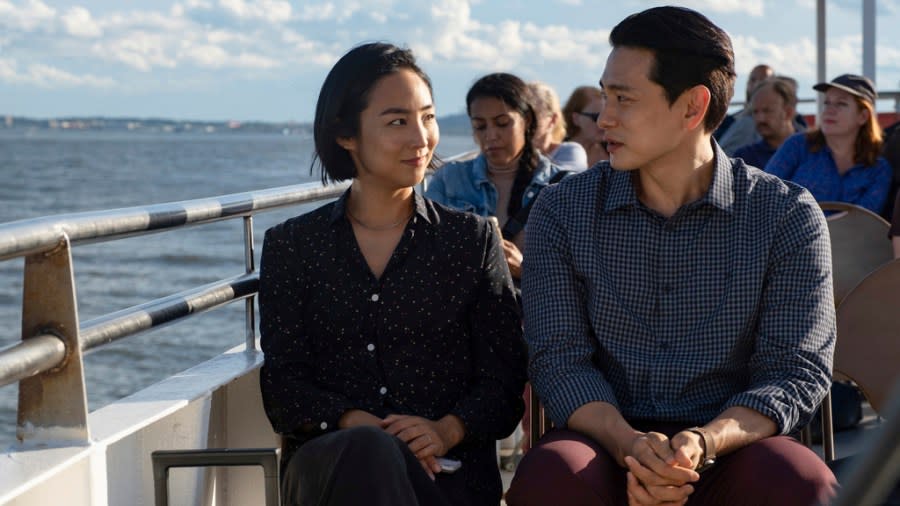 This image released by A24 shows Greta Lee, left, and Teo Yoo in a scene from “Past Lives.” (Jon Pack/A24 via AP)