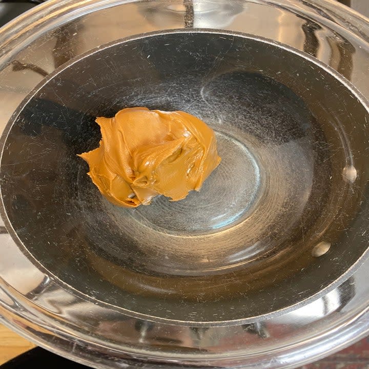 Cookie butter in a bowl over a double boiler