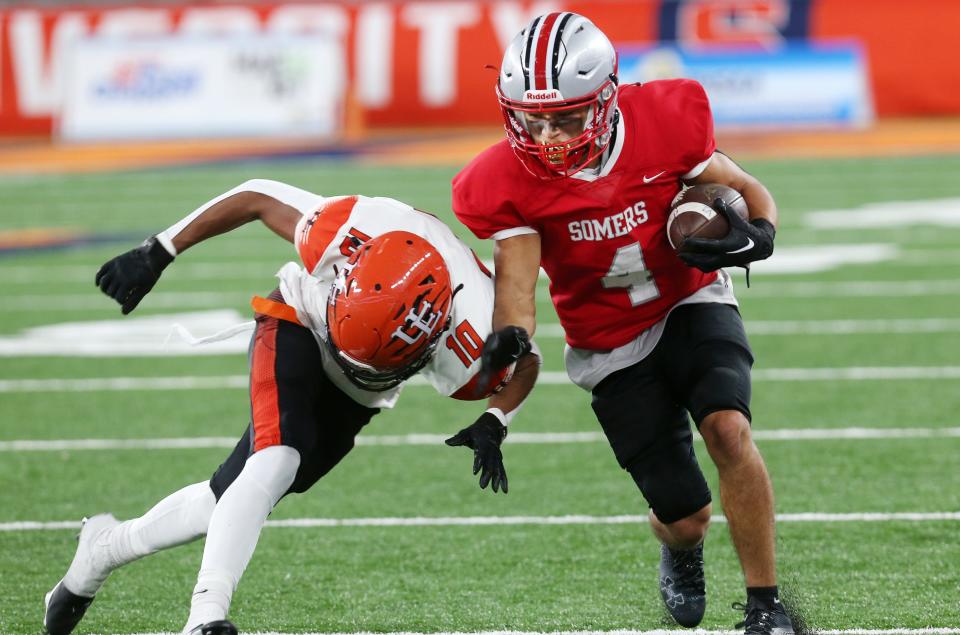 Somers Ravi Dass (4) looks for some running room in the Union-Endicott defense during the state Class A football championships at JMA Wireless Dome in Syracuse Dec. 3, 2022. 