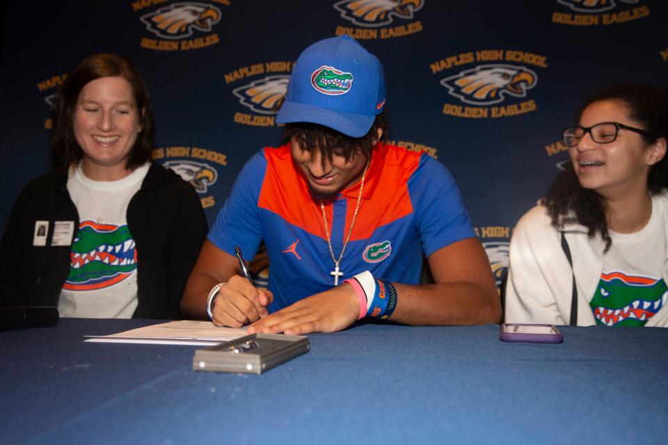 Naples’ Devin Moore announces his commitment to play college football at Florida, Wednesday, Dec. 15, 2021, at Naples High School in Naples, Fla.