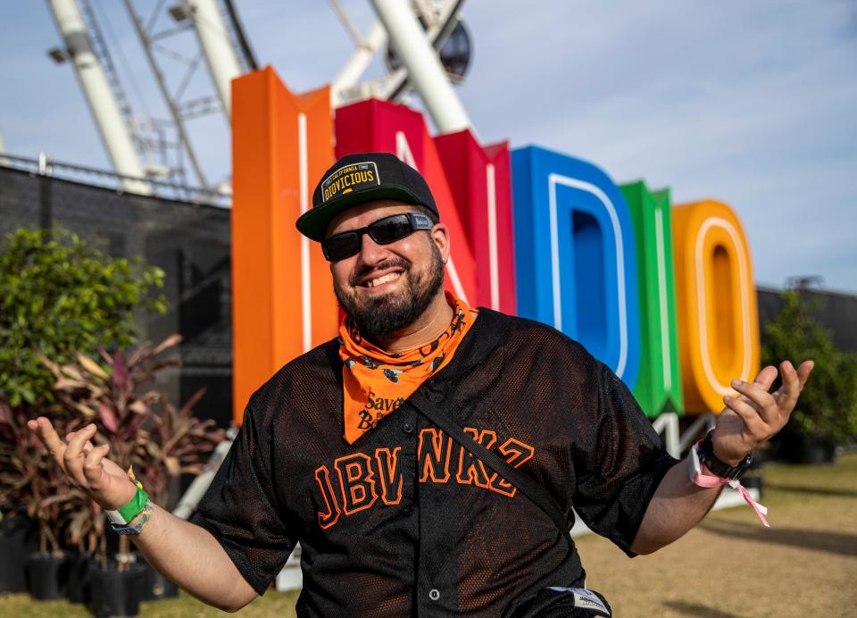 Adam Ex of La Quinta poses for a photo in front of the Indio sign during the Coachella Valley Music and Arts Festival at the Empire Polo Club in Indio, Calif., Saturday, April 22, 2023. 