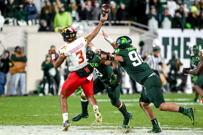 Michigan State's Jacub Panasiuk, right, and Itayvion Brown pressure Maryland's quarterback Taulia Tagovailoa during the fourth quarter on Saturday, Nov. 13, 2021, at Spartan Stadium in East Lansing. Brown was charged last fall in connection with a fight in the tunnel at the University of Michigan and again in March in East Lansing and was kicked off the team.