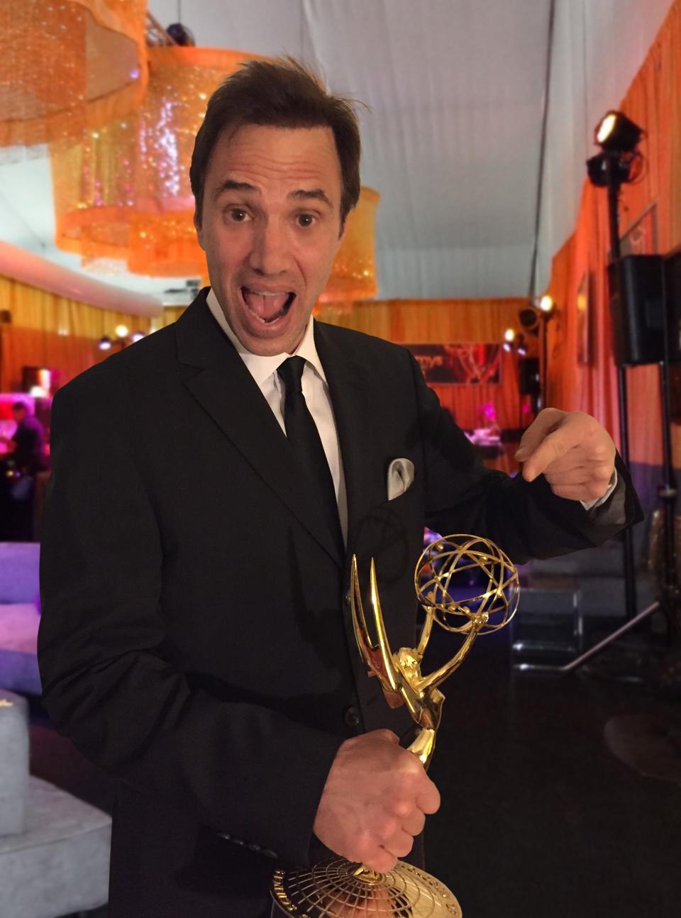 Paul Mecurio displays one of the Emmys he won for his work on late-night television.