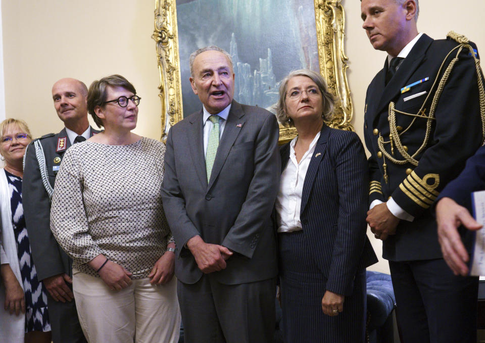 Senate Majority Leader Chuck Schumer, D-N.Y., flanked by Paivi Nevala, minister counselor of the Finnish Embassy, left, and Karin Olofsdotter, Sweden's ambassador to the U.S., welcomes diplomats from Sweden and Finland just before the Senate vote to ratify NATO membership for the two nations in response to Russia's invasion of Ukraine, at the Capitol in Washington, Wednesday, Aug. 3, 2022. (AP Photo/J. Scott Applewhite)