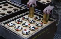 A soldier prepares blank shells to be used during a 41 gun salute in memory of Prince Philip at the Royal Artillery barracks in Woolwich, London, Saturday, April 10, 2021. Buckingham Palace officials announced Friday that Prince Philip, the husband of Queen Elizabeth II, has died . He was 99. (AP Photo/Alastair Grant, Pool)