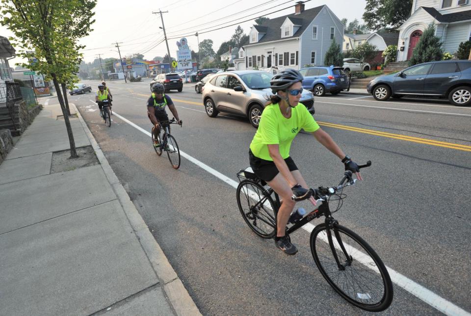 Quincycles members bike along Adams Street in Quincy on Monday, July 26, 2021.