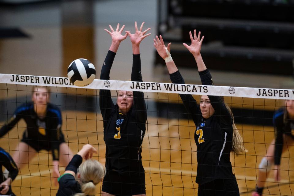 Castle’s Emma Watson (3) and Katie Kopshever (2) go for the block as the Castle Knights play the North Huskies during the IHSAA Class 4A Volleyball Sectional championship in Jasper, Ind., Saturday, Oct. 14, 2023.