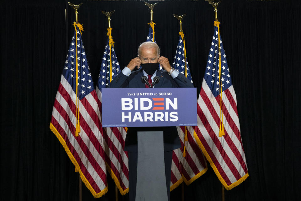 Former Vice President Joe Biden removes his face mask as he arrives to speak at a campaign event in August. (Photo: ASSOCIATED PRESS)