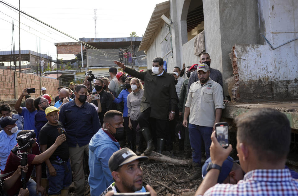 Venezuela's President Nicolas Maduro and first lady Cilia Flores visit the area flooded in Las Tejerias, Venezuela, Monday, Oct. 10, 2022. A fatal landslide fueled by flooding and days of torrential rain swept through this town in central Venezuela. (AP Photo/Matias Delacroix)