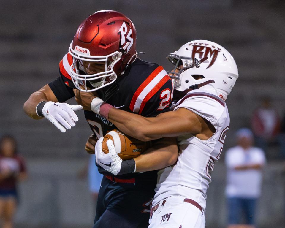 A Rancho Mirage defender tackles Jordan Johnson of Palm Springs in the high school football game between Palm Springs and Rancho Mirage on Sept. 29, 2023.