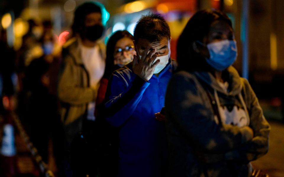 Residents queue for a mandatory coronavirus test in the Jordan area of the Yau Tsim Mong district of Kowloon - AFP