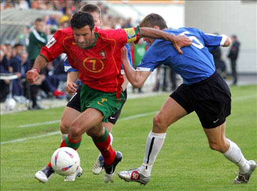 Portugal's Luis Figo (L) vies with Estonia's Urmas Rooba (R) during their World Cup 2006 qualifier football match at the A. le Coq Arena in Tallinn 08 June 2005. AFP PHOTO/ NICOLAS ASFOURI