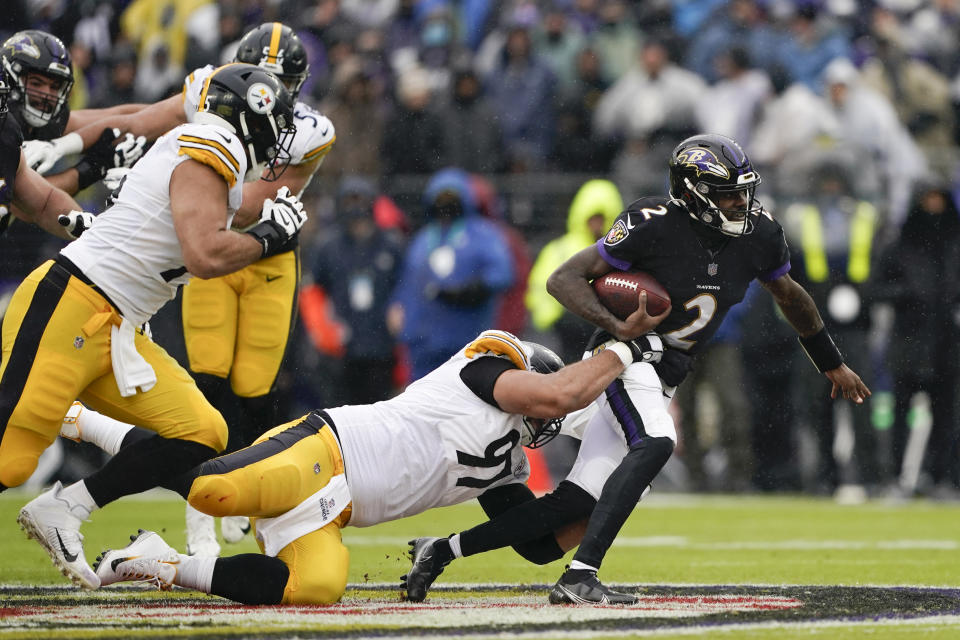 Pittsburgh Steelers defensive end Cameron Heyward (97) attempts to bring down Baltimore Ravens quarterback Tyler Huntley (2) as he scrambles for yardage during the first half of an NFL football game, Sunday, Jan. 9, 2022, in Baltimore. (AP Photo/Evan Vucci)