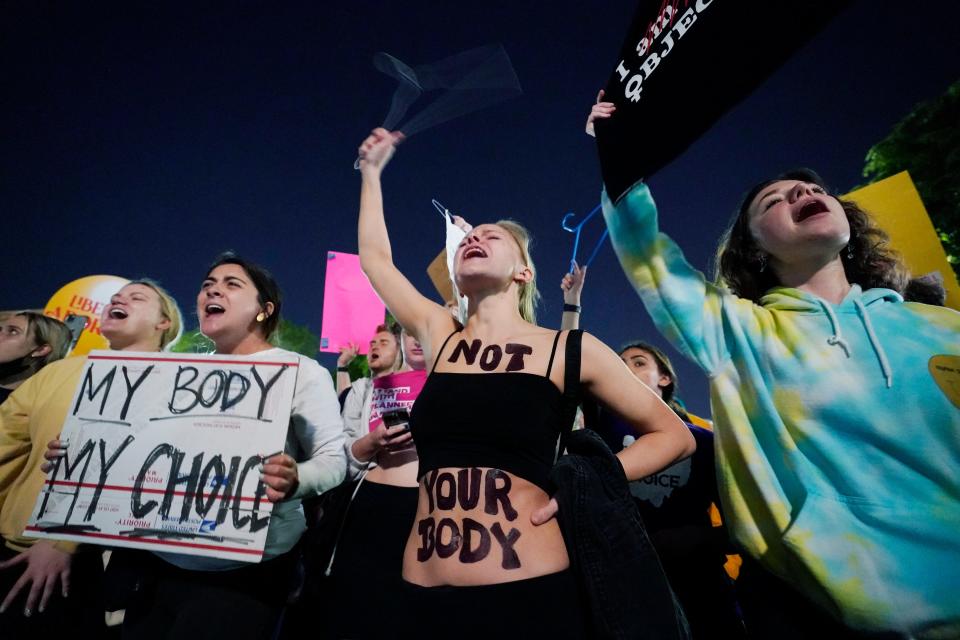 A crowd of people gather outside the Supreme Court, early Tuesday, May 3, 2022 in Washington.