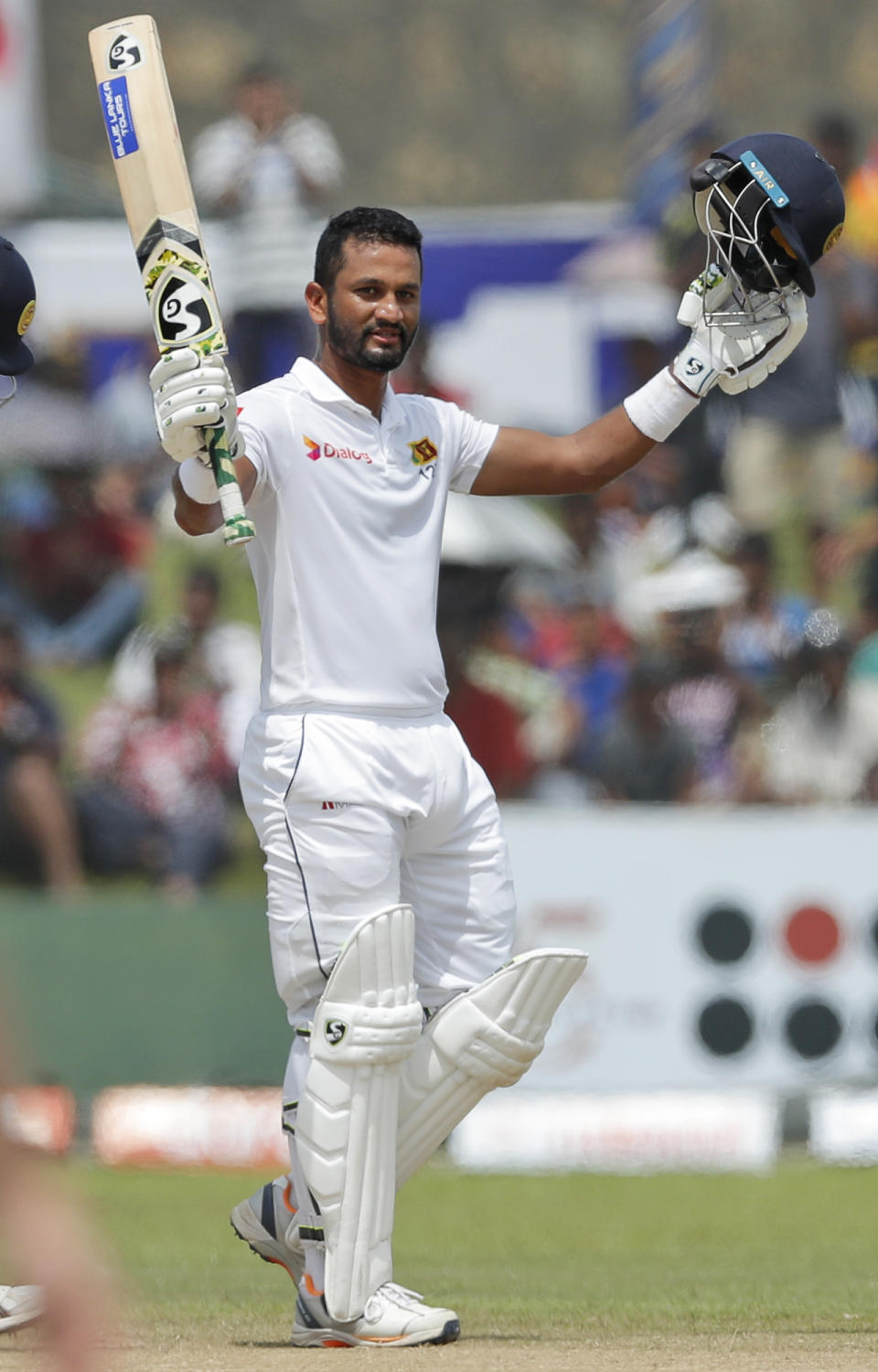 Sri Lankan's Dimuth Karunaratne celebrates scoring a century during the day five of the first test cricket match between Sri Lanka and New Zealand in Galle, Sri Lanka, Sunday, Aug. 18, 2019. (AP Photo/Eranga Jayawardena)