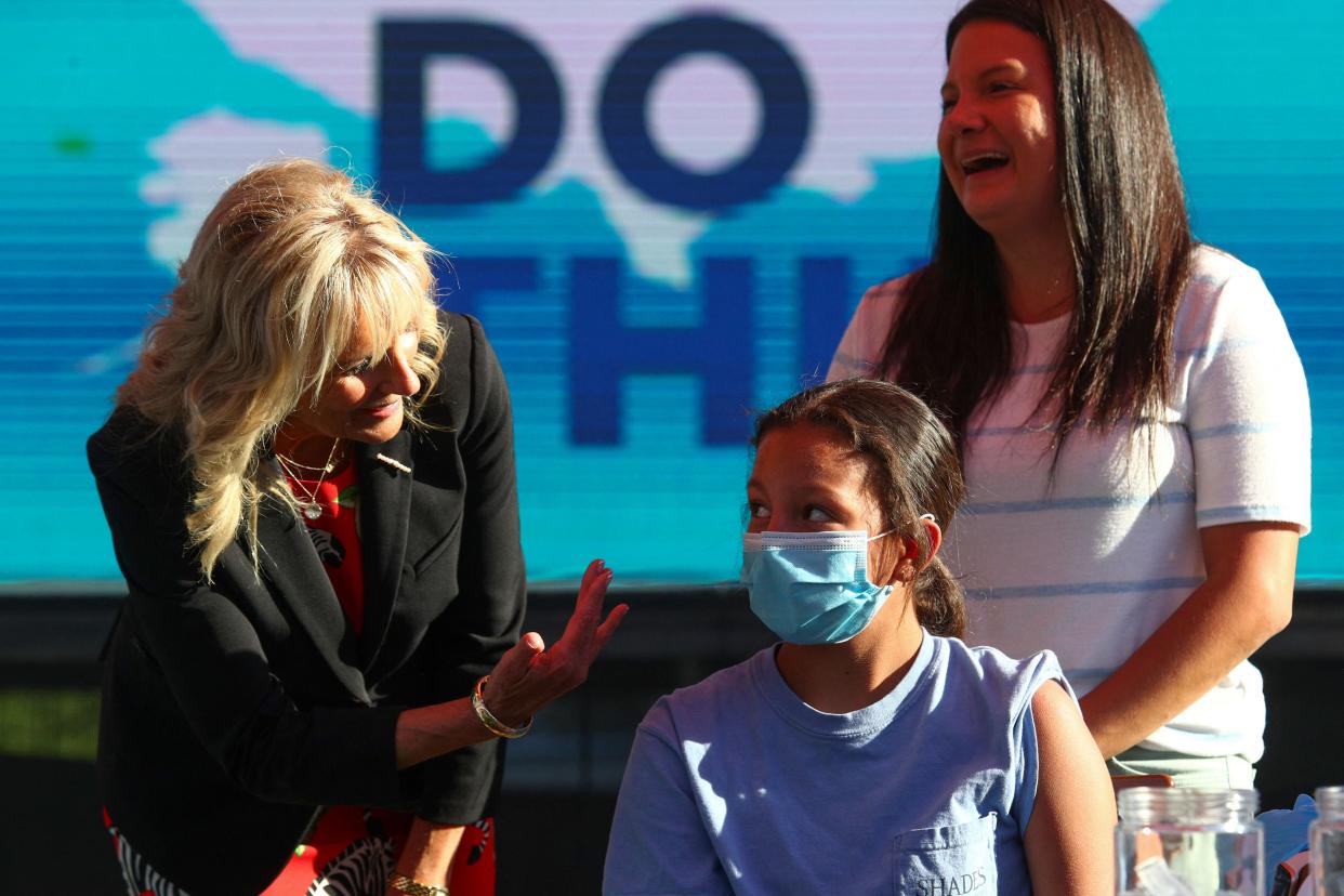 US first lady Jill Biden (L) speaks to Adriana Lyttle, 12, as she receives her vaccine at a Covid-19 vaccination  (POOL/AFP via Getty Images)