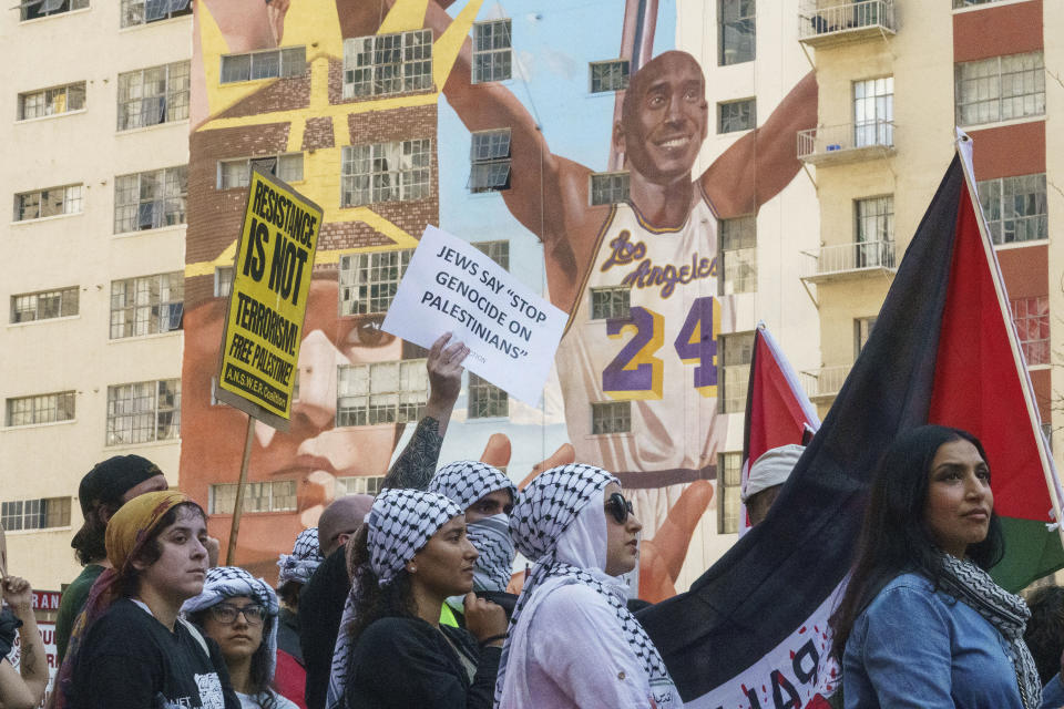 People participate during a pro-Palestinian march calling for a ceasefire in Gaza, Saturday, Oct. 21, 2023, downtown Los Angeles. (AP Photo/Damian Dovarganes)