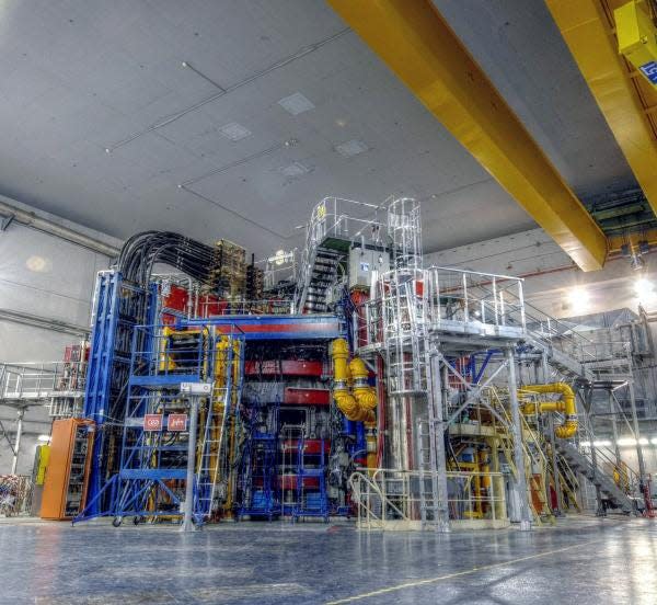 The exterior of a tokamak, a large device surrounded by metal ladders and scaffolding