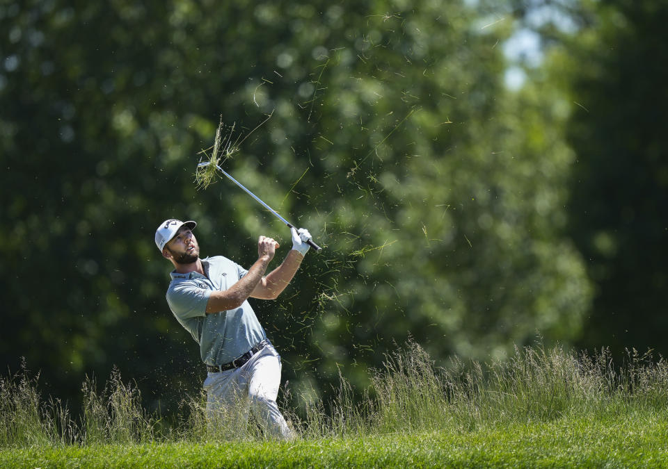 Sam Burns blasts out of the tall grass on the first hole during the second round of the Canadian Open golf tournament in Hamilton, Ontario, Friday May 31, 2024. (Nathan Denette/The Canadian Press via AP)