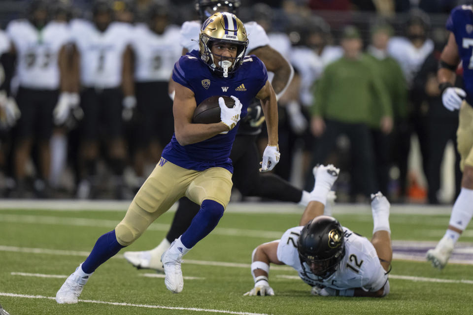 FILE - Washington wide receiver Jalen McMillan runs with the ball during an NCAA college football game against Colorado, Saturday, Nov. 19, 2022, in Seattle. Washington opens their season at home against Boise State on Sept. 2.(AP Photo/Stephen Brashear, File)