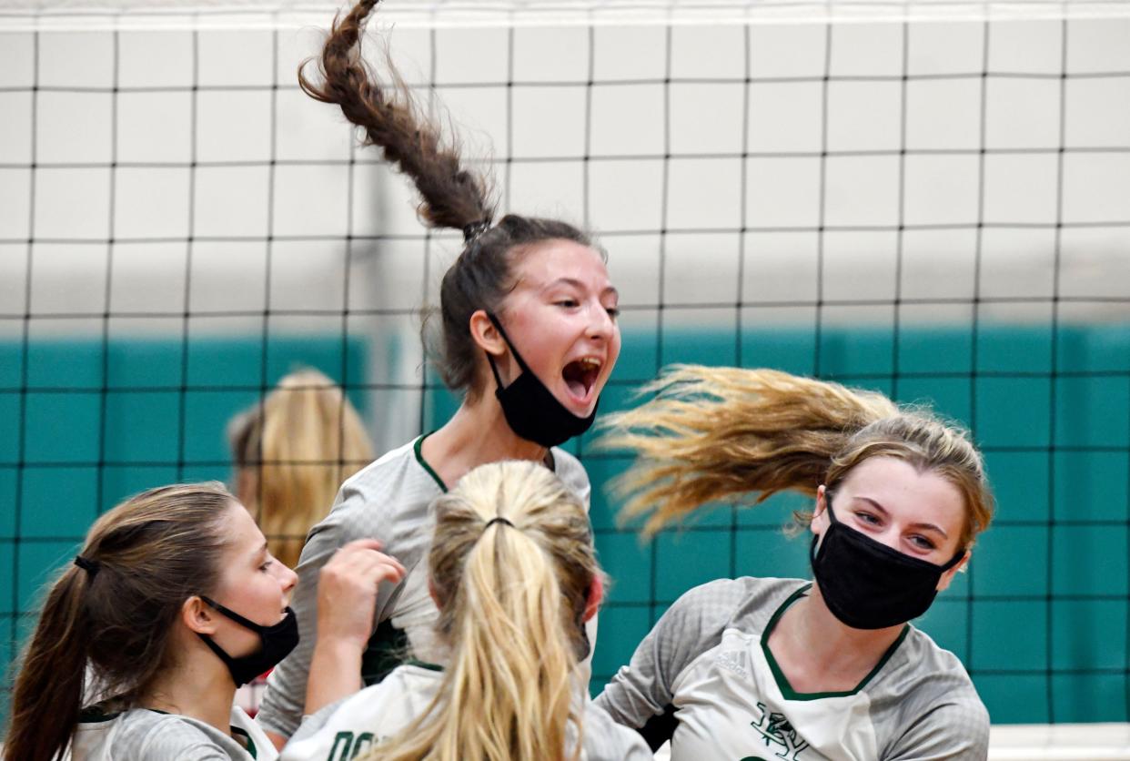 Dennis-Yarmouth players celebrate after winning the fourth set against Barnstable on Tuesday.