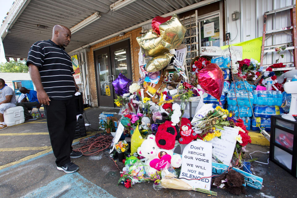 Cleve Dunn Jr. takes a moment to reflect at an impromptu memorial for Alton Sterling at the Triple S Food Mart.