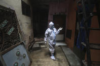 A health worker calls out to people to come out for screening for COVID-19 symptoms in Dharavi, one of Asia's biggest slums, in Mumbai, India, Tuesday, Aug. 11, 2020. India has the third-highest coronavirus caseload in the world after the United States and Brazil. (AP Photo/Rafiq Maqbool)