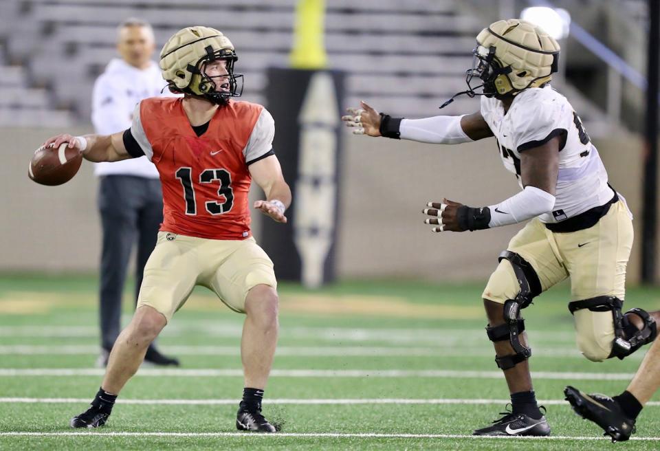 Army quarterback Bryson Daily (13), a rising senior, looks for a receiver during the Black-and-Gold football scrimmage at West Point's Michie Stadium on April 12, 2024. DANNY WILD