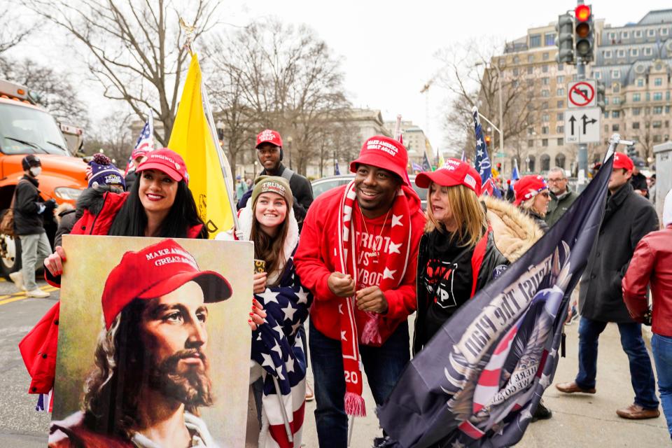 Protesters take a photo with rapper Bryson Gray of High Point, N.C., a vocal supporter of former President Donald Trump, in Washington Jan. 6.