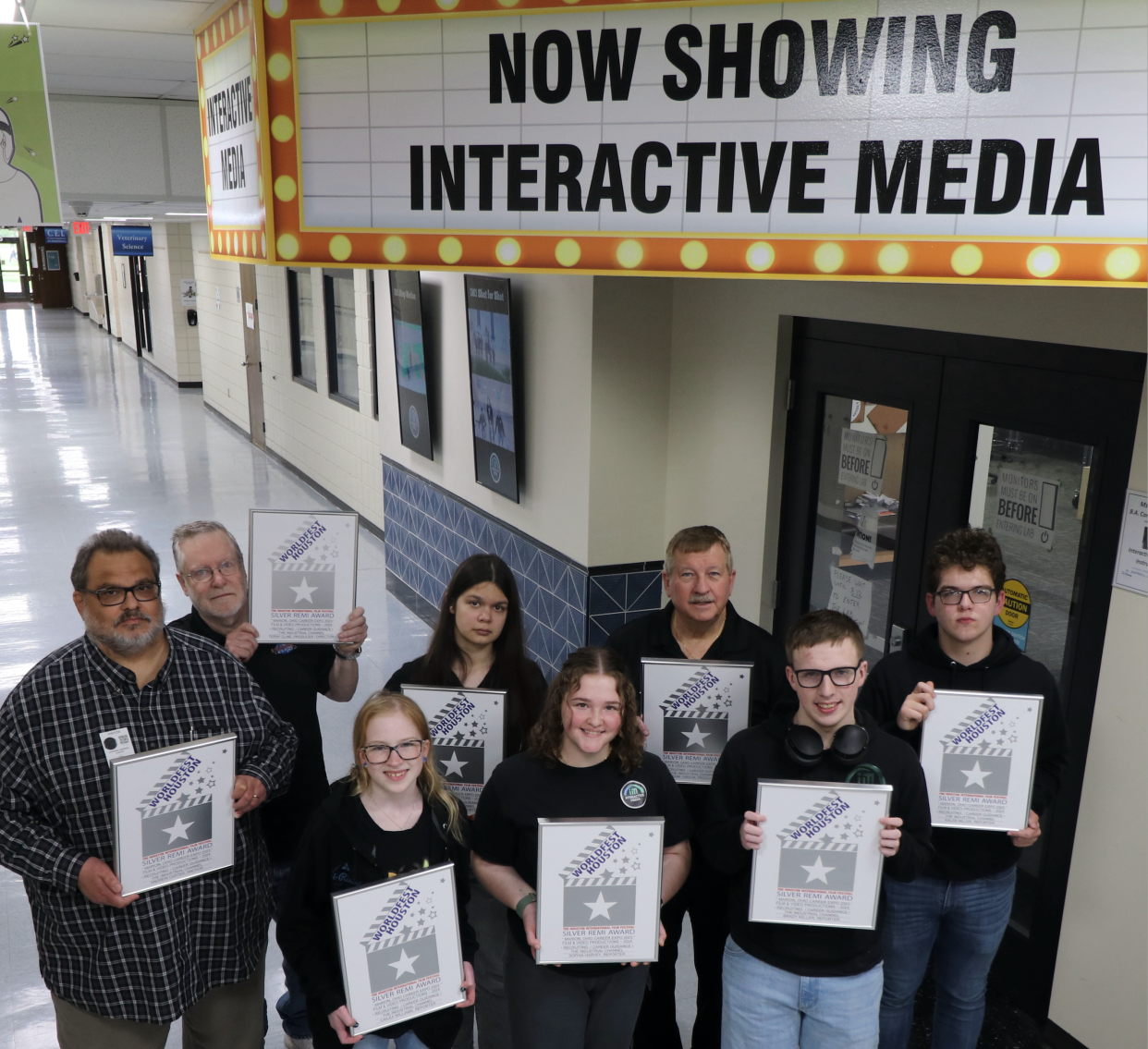 Displaying their Silver REMI Award certificates presented to them for their "Marion Career EXPO 2023" video are Andrew Carter, left, Terry Cline, Cailea Williams, Kassidy DeSouza, Sophia Harvey, Frank Gibson, Brady Keller and Kaleb Miller. Not pictured is Kevin Evanoski.