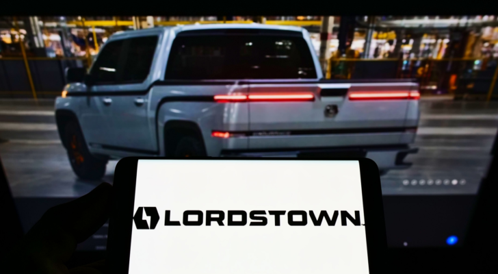 Person holding smartphone with logo of US automotive company Lordstown Motors Corporation (RIDE) on screen in front of website. Focus on phone display. Unmodified photo.