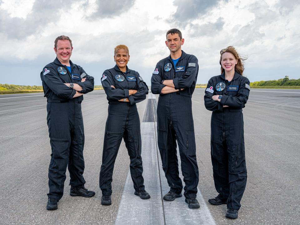 inspiration4 crew poses with arms crossed on the tarmac at kennedy space center in florida