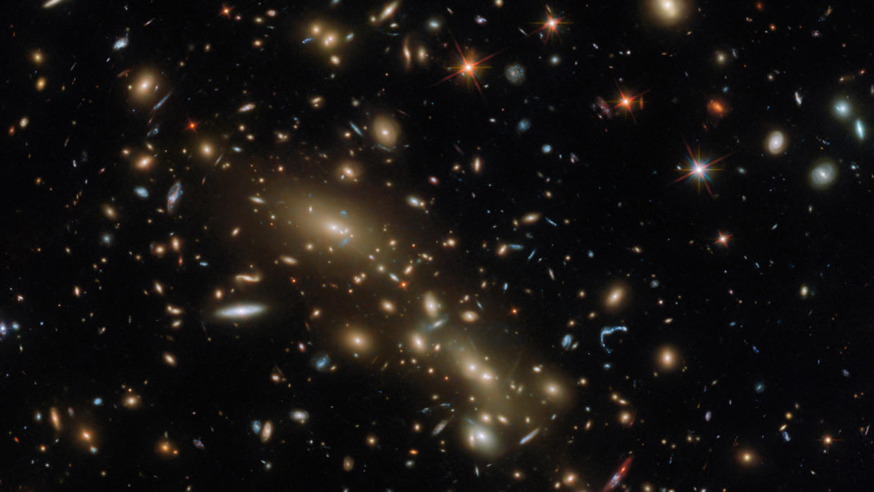  A spattering of galaxies litters the black of space. 