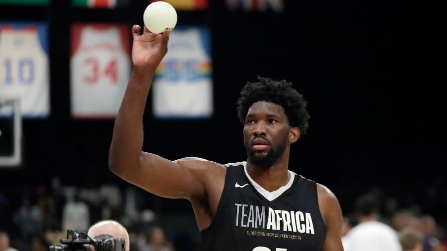 Team Africa’s Joel Embiid throws balls to fans during the NBA Africa Game between Team Africa and Team World, at the Sun Arena in Pretoria, South Africa, Saturday, Aug. 4, 2018. (AP Photo/Themba Hadebe)