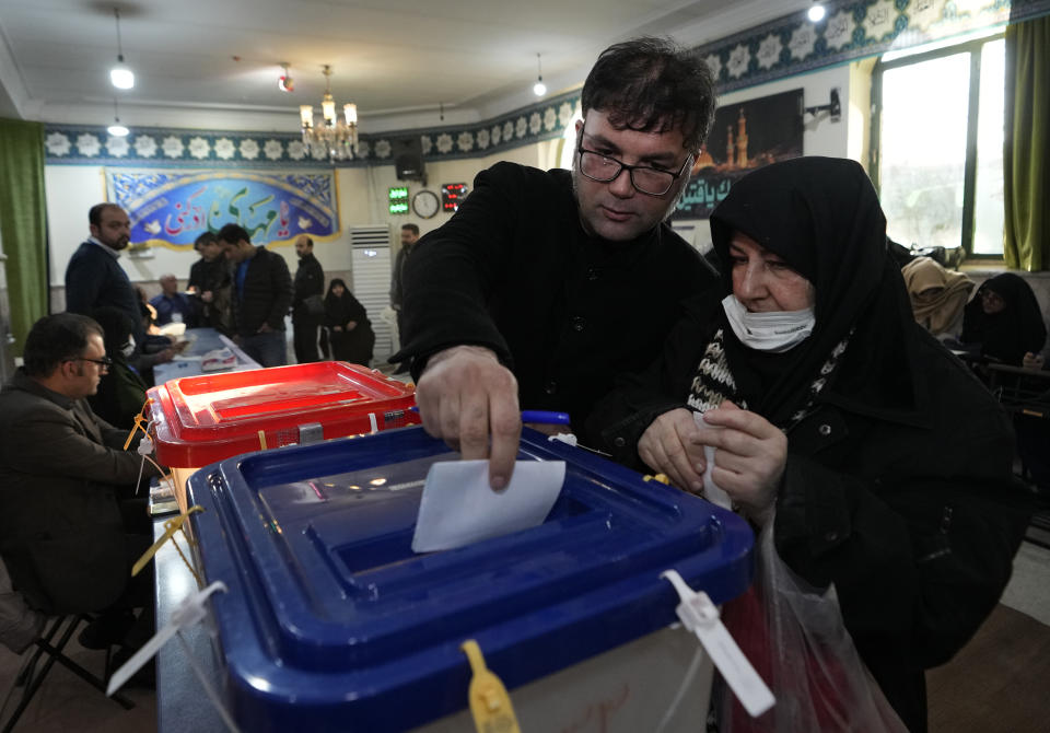 Voters cast their ballots during the parliamentary and Assembly of Experts elections at a polling station in Tehran, Iran, Friday, March 1, 2024. Iran held the country's first election since the mass 2022 protests over mandatory hijab laws after the death in police custody of Mahsa Amini, with questions looming over just how many people will turn out at the polls. (AP Photo/Vahid Salemi)