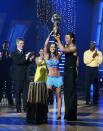 Monaco, “Dancing’s” inaugural winner, holds up the mirror ball trophy.