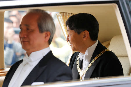 Japan’s Emperor Naruhito looks from his vehicle upon arriving at the Imperial Palace in Tokyo, Japan May 1, 2019. REUTERS/Kim Kyung-Hoon