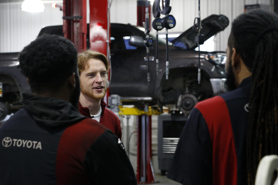 Eric Tarver talks with employees on Wednesday, March 30, 2022, at the Toyota dealership his family owns in Lake Charles, Louisiana. Tarver, who's also a school board member for Calcasieu Parish, is one of many residents who support the expansion of the liquified natural gas, or LNG, industry in the Lake Charles area. Though Louisiana offers a property tax break of 10 years to companies that build LNG terminals there, Tarver says the tax benefits are still huge for the schools and other government agencies. He also says resulting jobs have been a "shot in the arm." To opponents of the LNG expansion on the Gulf Coast, he says, "The global demand for LNG is going to be there whether the U.S. serves it or not." (AP Photo/Martha Irvine)